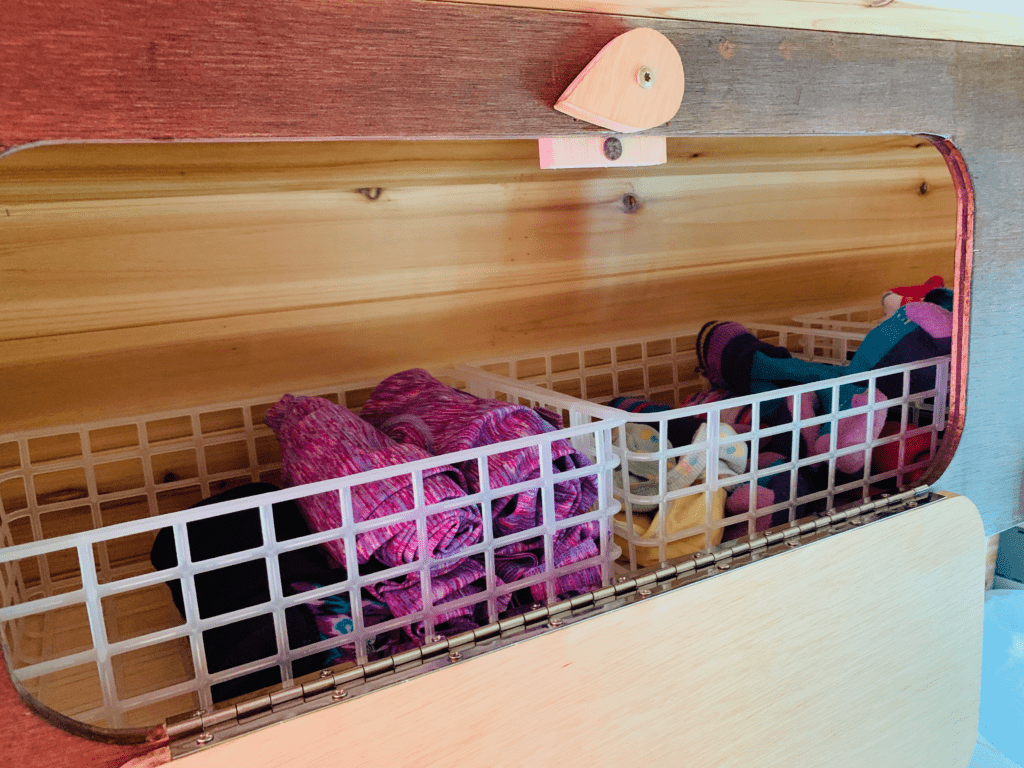 The Container Store plastic grid baskets organizing closet space in van