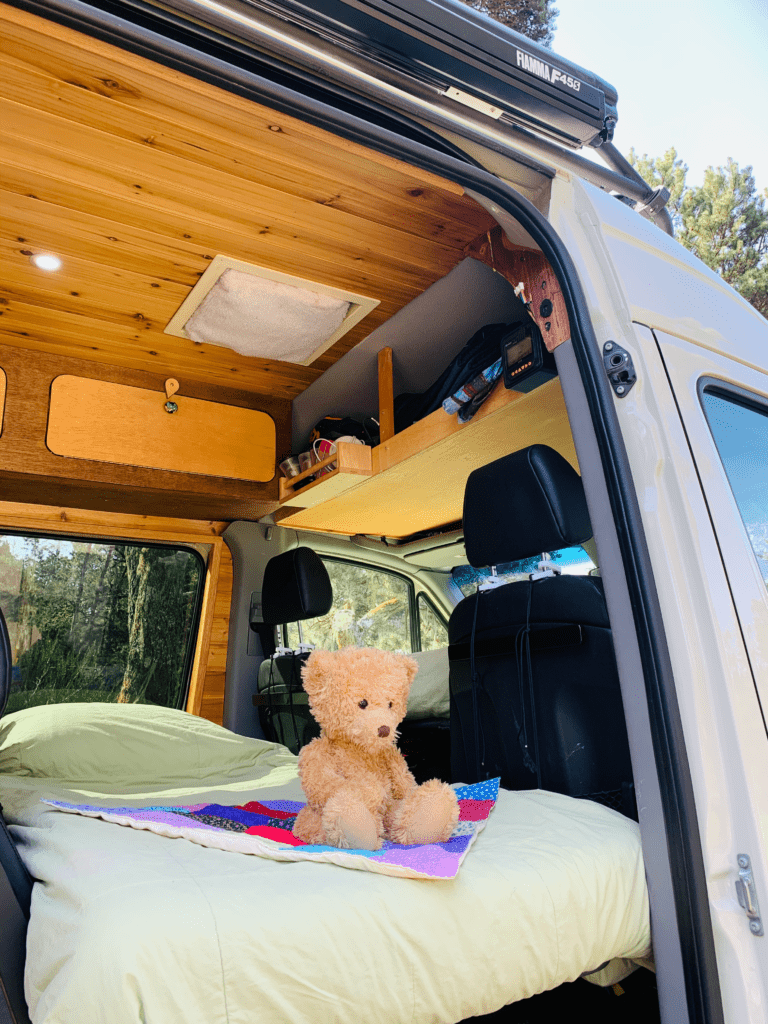 van double bunk system with comfortable twin size beds and a teddy bear