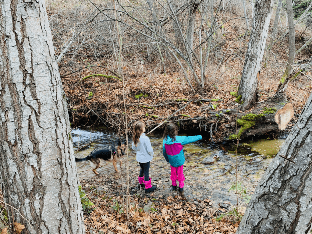 Kids exploring creekside during wintertime in Ashland, Oregon