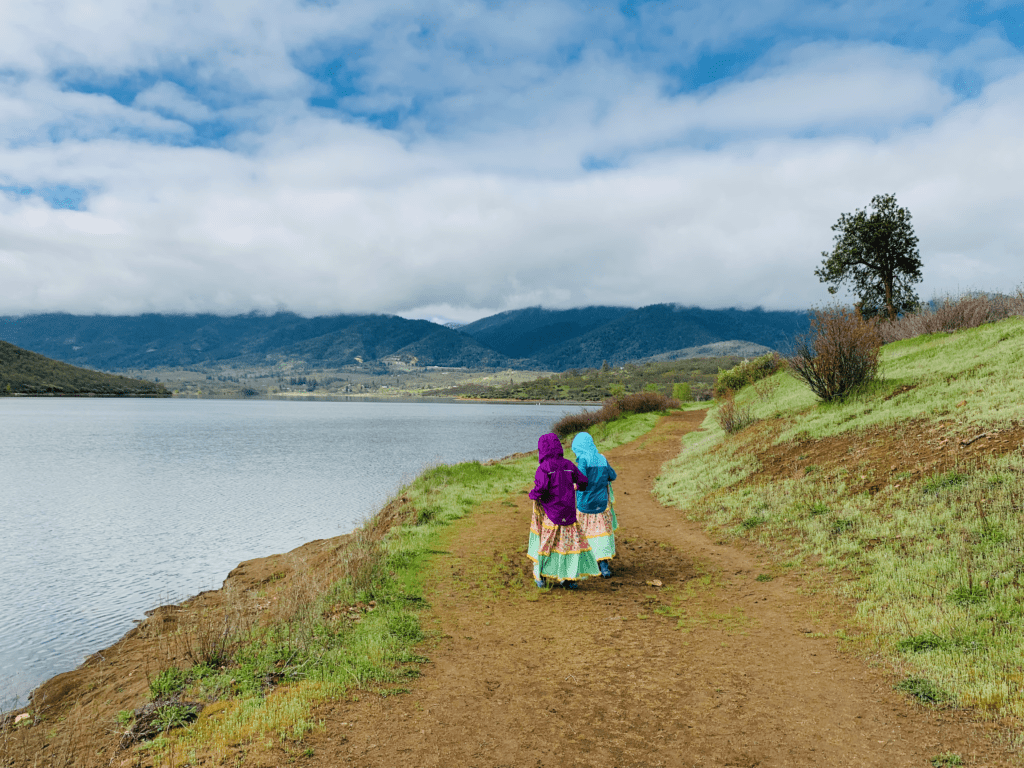 Magic land at Emigrant Lake with girls on trail in long dresses