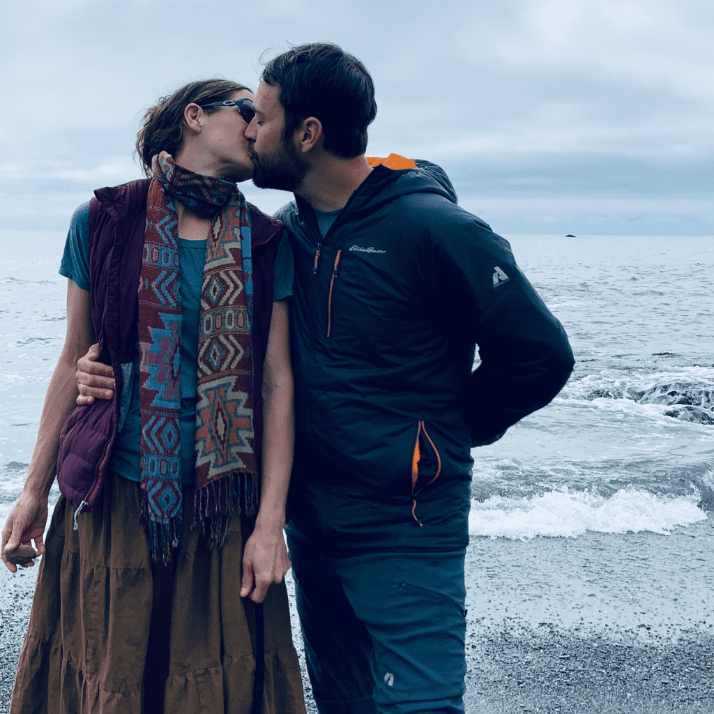 Kissing with an Eddie Bauer jacket and Indian shawl with the ocean in the background