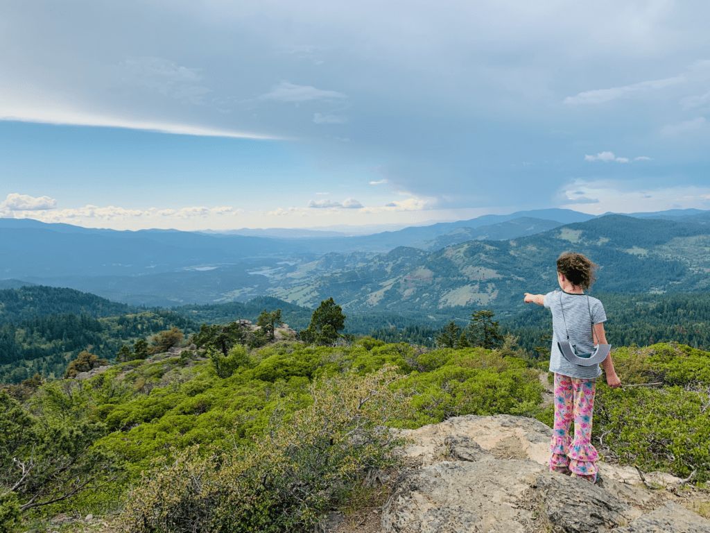 Girl pointing to the horizon on the top of Hobart Bluff on the Pacific Crest Trail