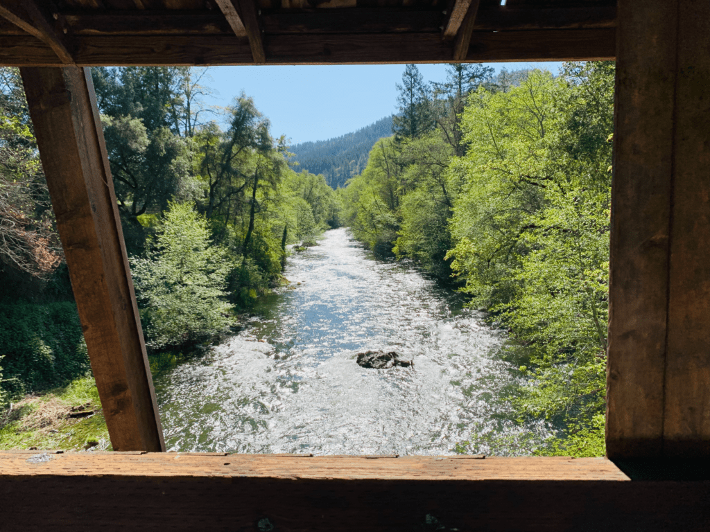 A river flowing through the window of a covered bridge in Oregon