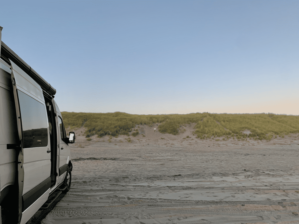 Beach Access Point at Fort Stevens with kids playing on the sand and the Sprinter Van in the background