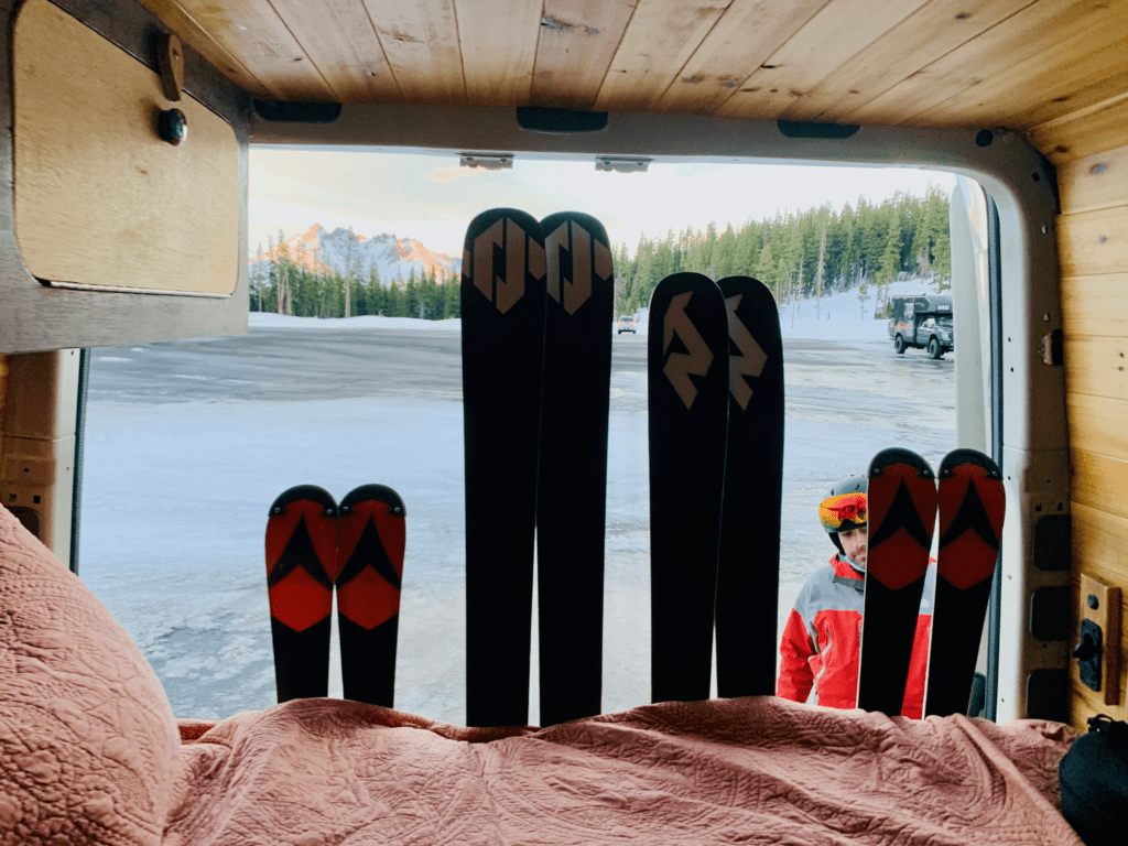 Custom Van Ski Rack with four pairs of play skis attached to back of van with the the Cascades in the sunset in the background