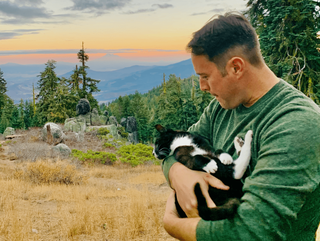 Forever Vata Man in our Arms Tuxedo Cat Looking into Sunset