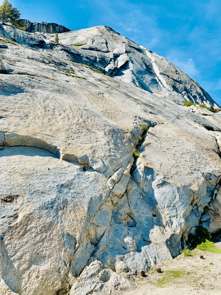 Strong as the massive Granite boulders of Tuolumne Meadows in Yosemite with bright blue sky in the background