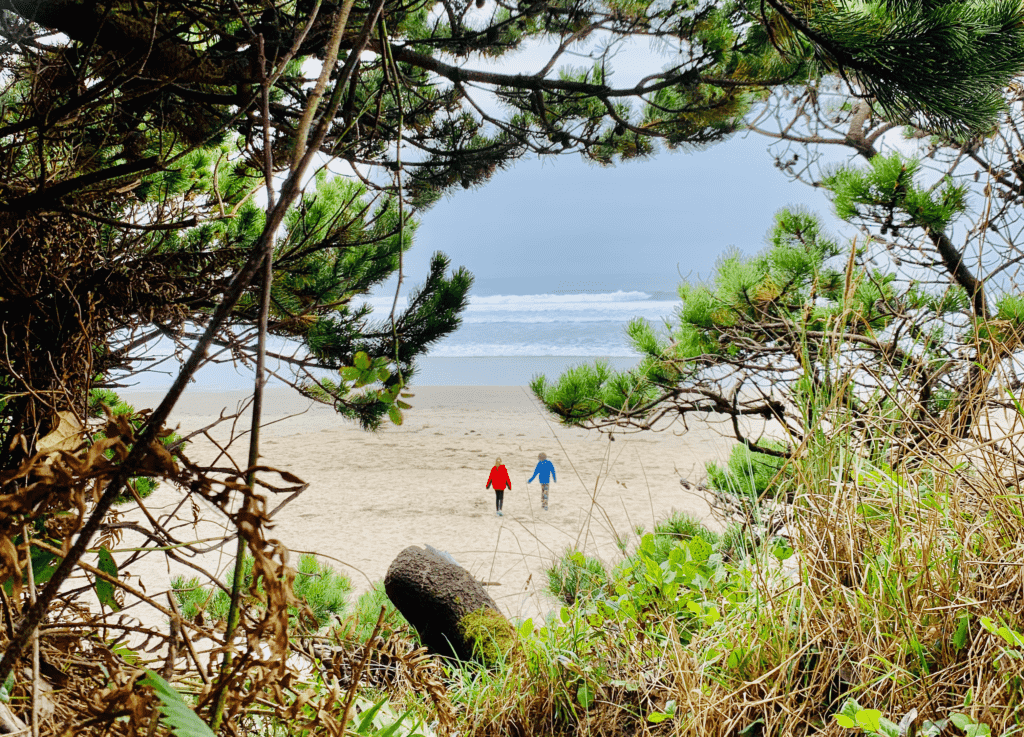 Oregon Coast Kids in Tree Frame with Pacific Ocean waves rolling in the background