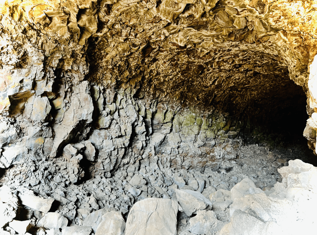 Down the lava tube at Lava Beds National Monument with a circular underground tube of igneous rock