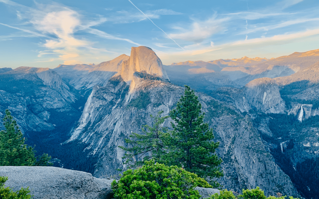 Half Dome View from Glacier Point with granite rocks cloud streaks and sunset in the background